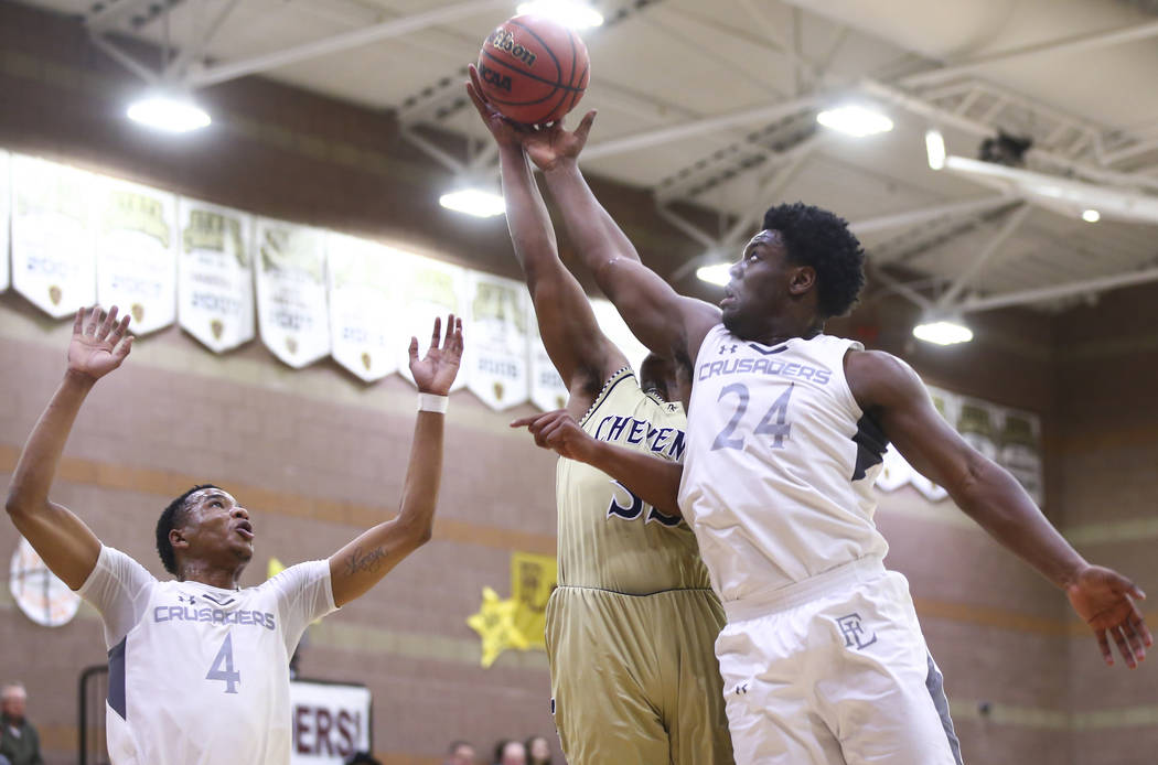 Faith Lutheran’s D.J. Heckard (24) goes for a rebound against Cheyenne’s Mike Re ...