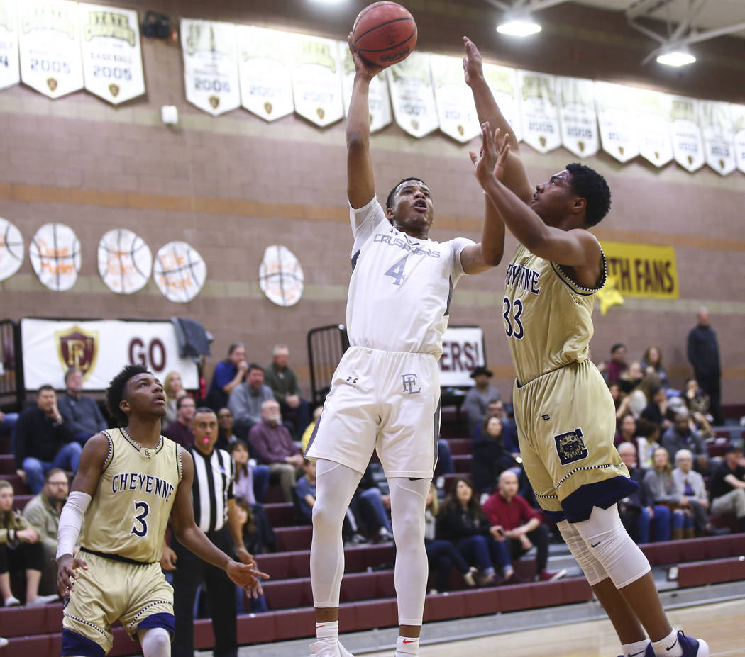 Faith Lutheran’s Sedrick Hammond (4) goes to the basket against Cheyenne’s Mike ...