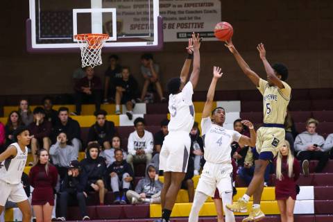 Cheyenne’s Glenn Taylor (5) shoots over Faith Lutheran’s Azavier Johnson (5) and ...