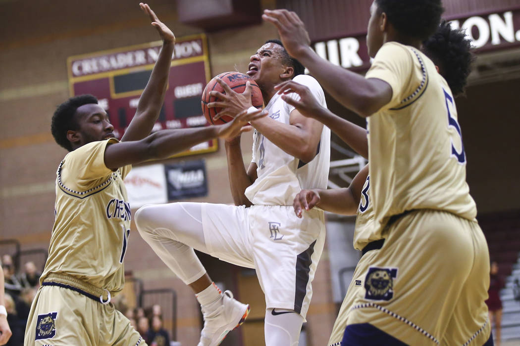 Faith Lutheran’s Sedrick Hammond (4) goes to the basket against Cheyenne’s De&#8 ...