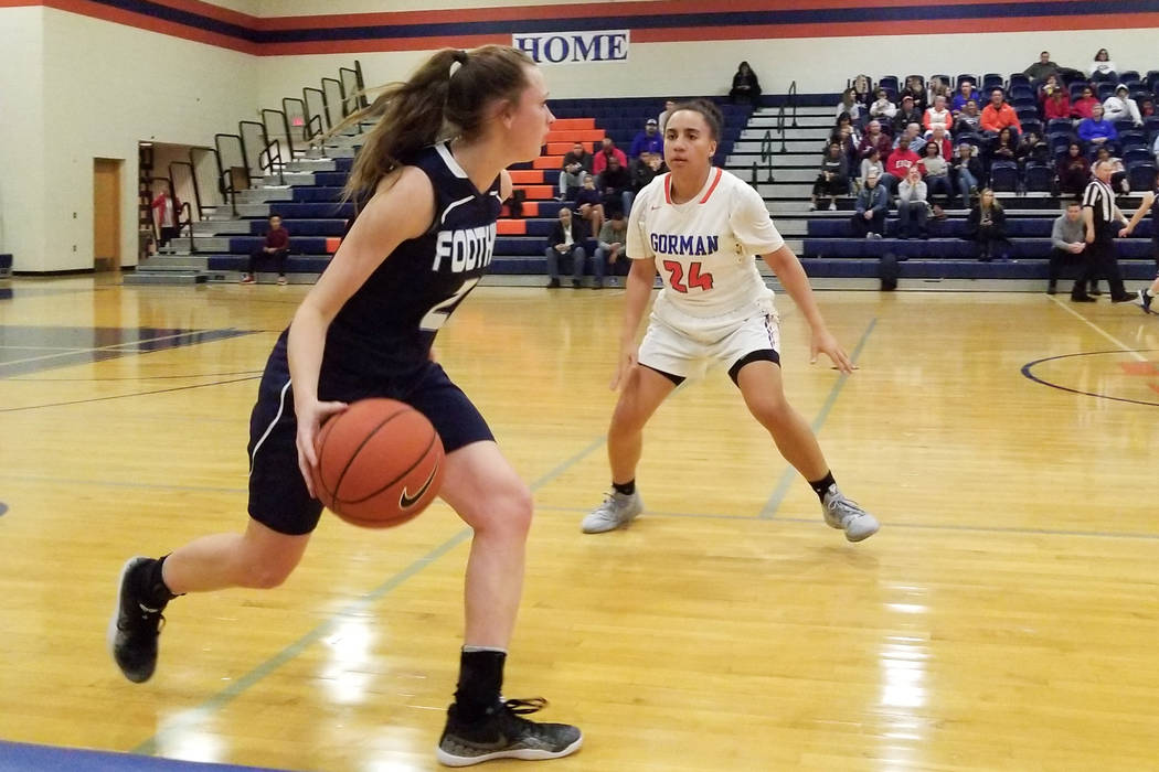 Foothill’s Aqui Williams, left, brings the ball down the court as Bishop Gorman’ ...