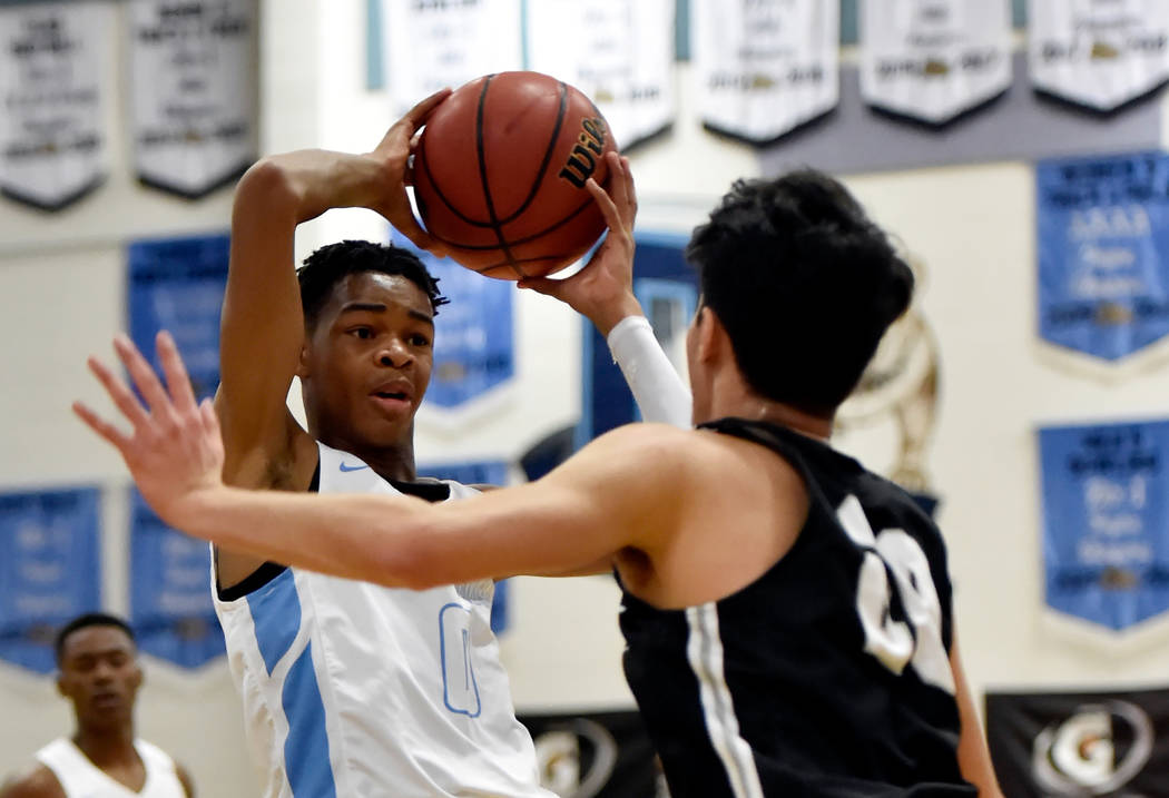 Centennial’s Chris Dockery (1) looks to pass around Palo Verde’s Sebastian Bejao ...