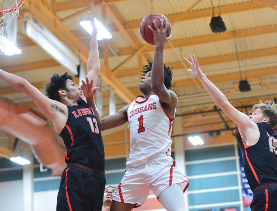 Coronado’s Jaden Hardy (1) takes a shot over Liberty’s Terrance Marigney (13) in ...