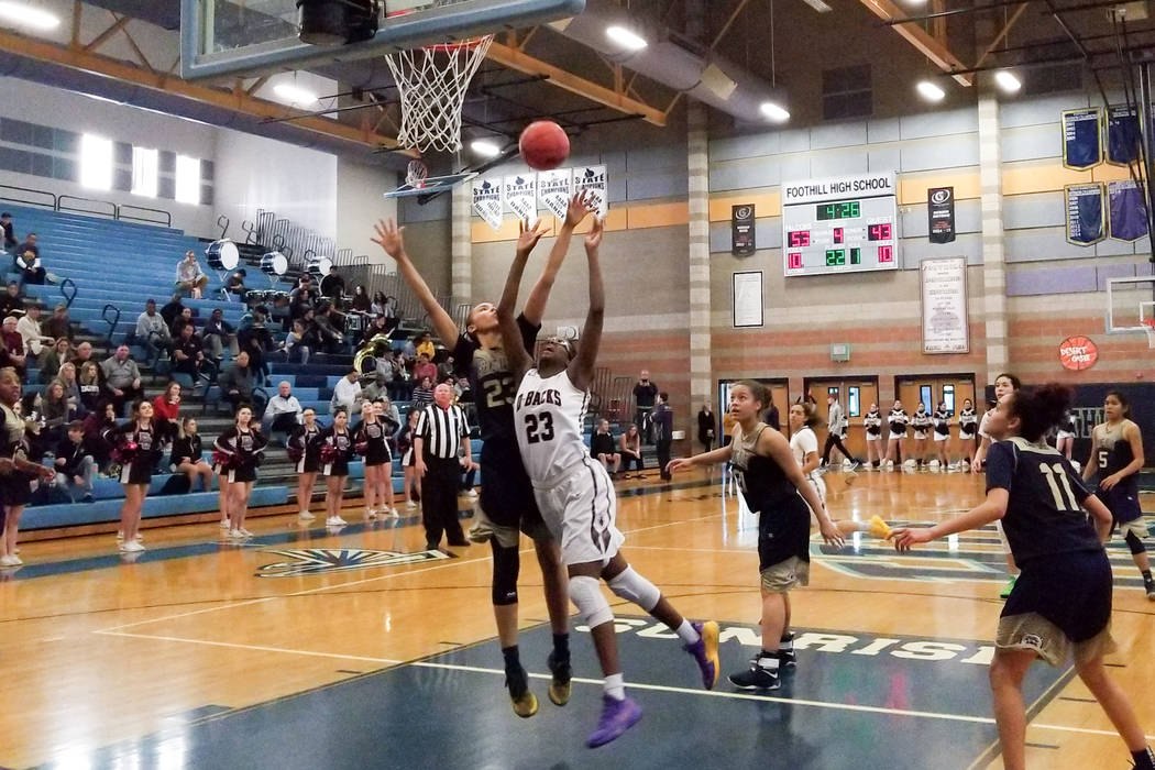 Desert Oasis’ Desi-Rae Young shoots over Spring Valley’s Alexus Quaadman during ...