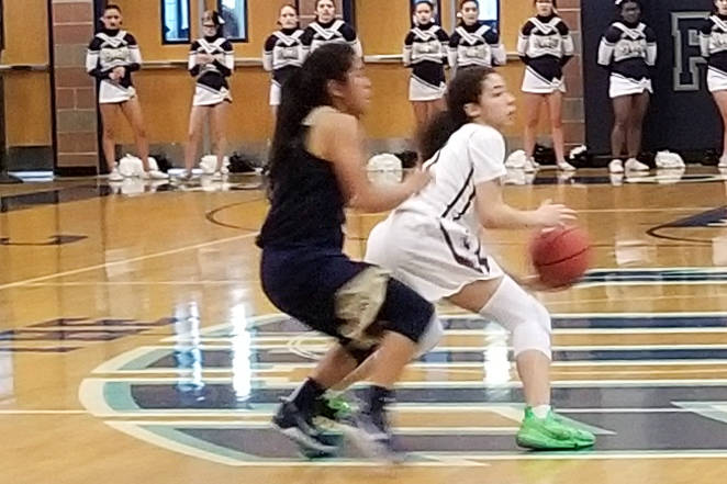 Desert Oasis’ Olivia Biggers is defended by Spring Valley’s Chelsea Camara durin ...