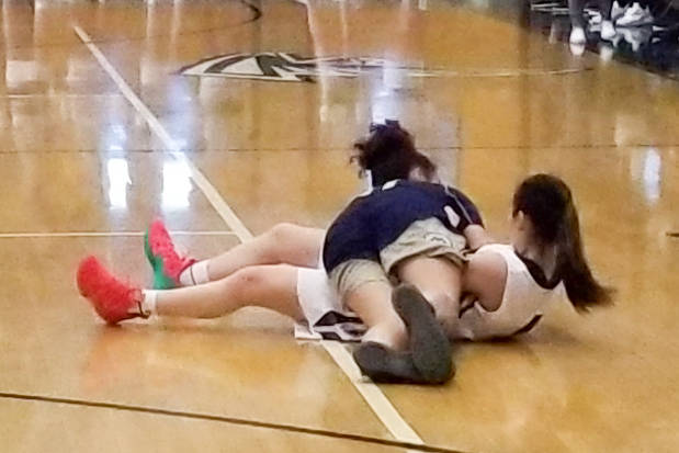 Desert Oasis’ Briann Clark, bottom, battles with for a loose ball with Spring Valley&# ...