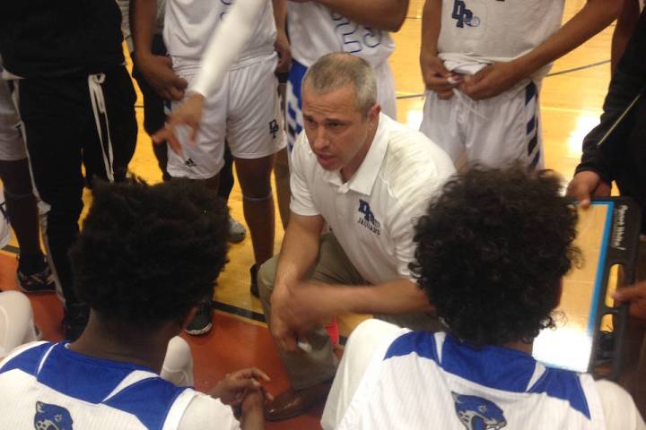 Desert Pines coach Mike Uzan talks to his team between quarters of the Jaguars’ 84-67 ...