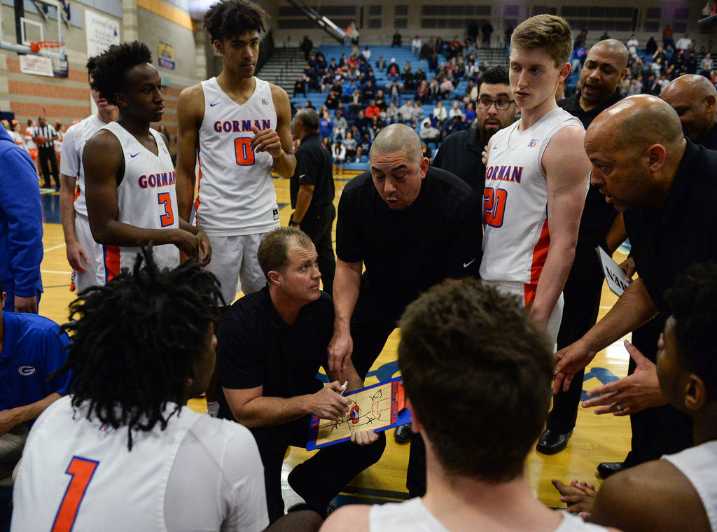 Bishop Gorman’s coaches talk to the team during a timeout during a game against Corona ...