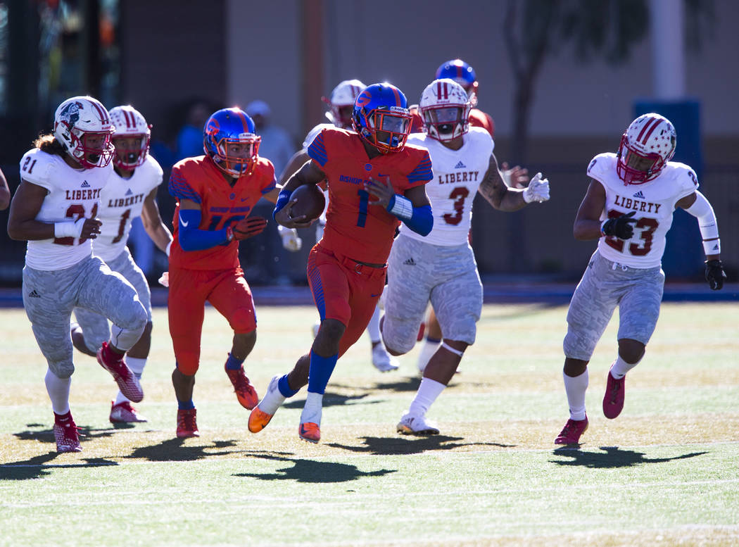 Bishop Gorman’s Micah Bowens (1) breaks past Liberty defenders for a touchdown during ...