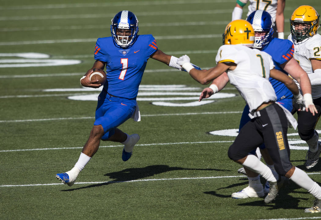 Bishop Gorman quarterback Micah Bowens (1) runs the ball against Bishop Manogue’s Elij ...