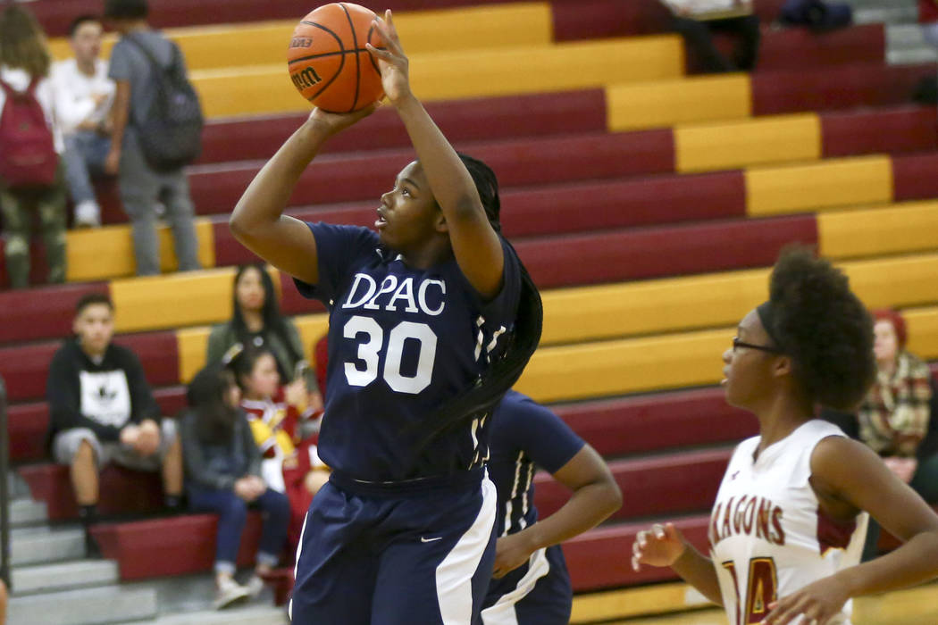 Democracy Prep senior Sharmayne Finley (30) shoots in front of Del Sol’s Nakala Nadeau ...