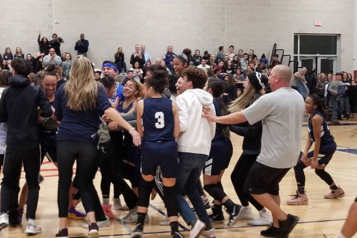 Calvary Chapel players and fans storm the court after the team’s 47-43 win over Needle ...