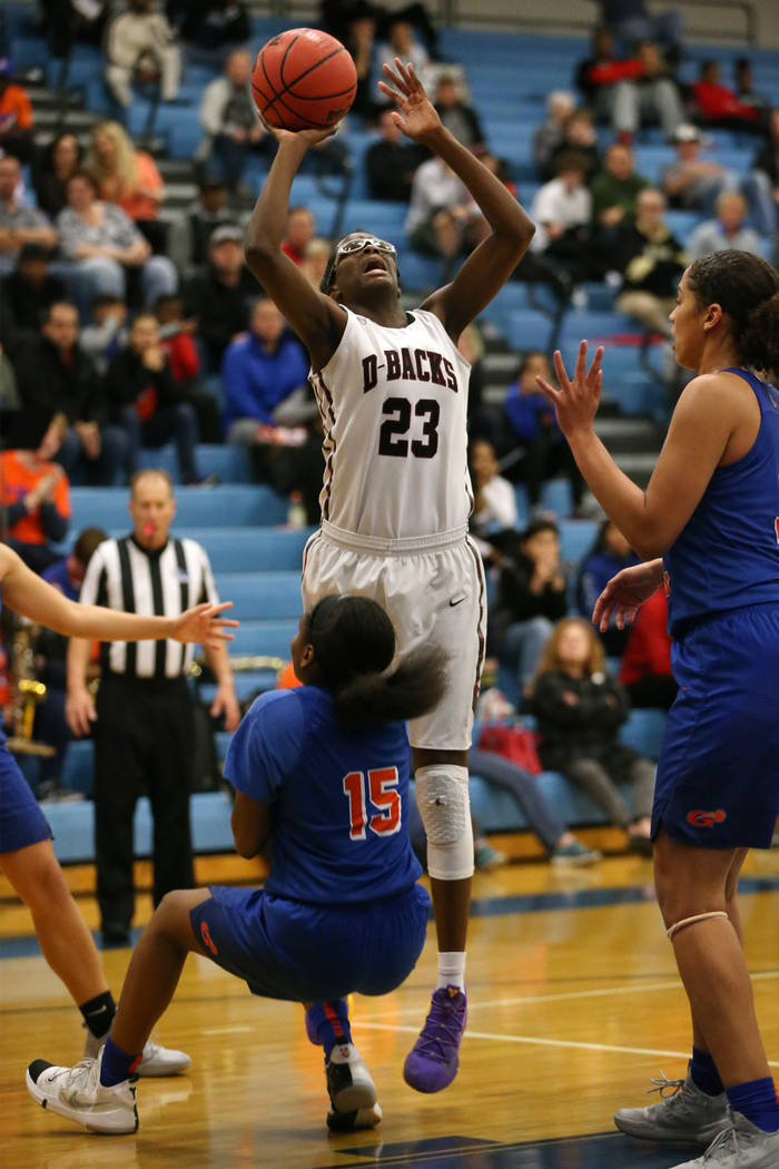 Bishop Gorman’s Asya Bey (15) takes a charge from Desert Oasis’ Desi-Rae Young ( ...