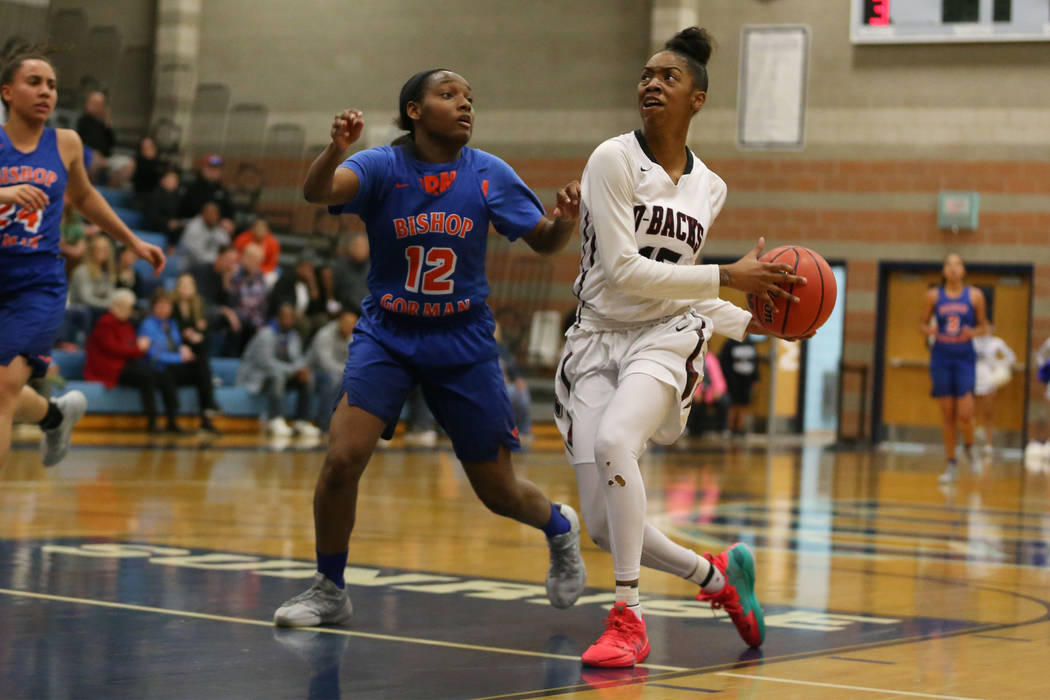 Bishop Gorman’s Aaliyah Bey (12) defends against Desert Oasis’ Ahmaya Smith (15) ...