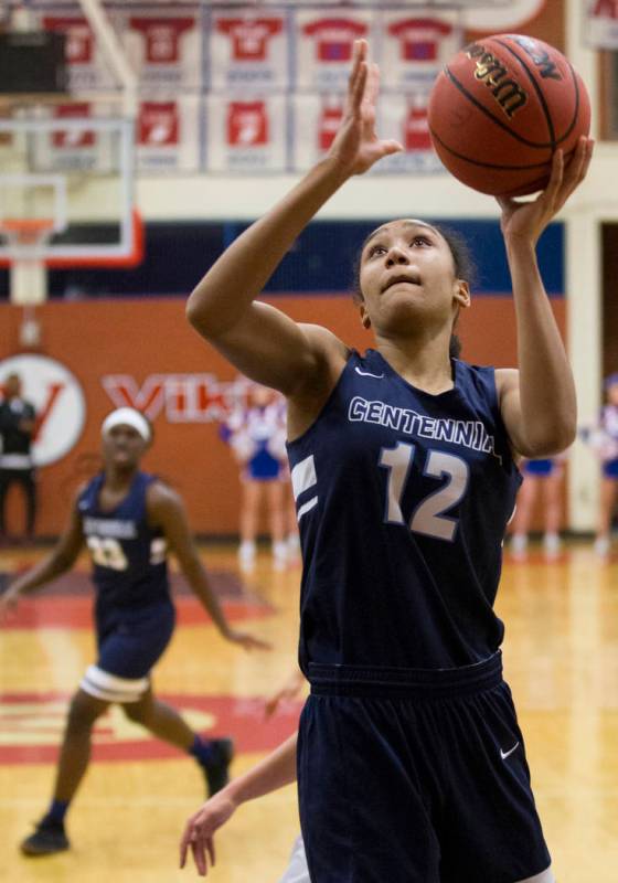 Centennial junior Aishah Brown (12) converts a fast-break layup in the fourth quarter during ...