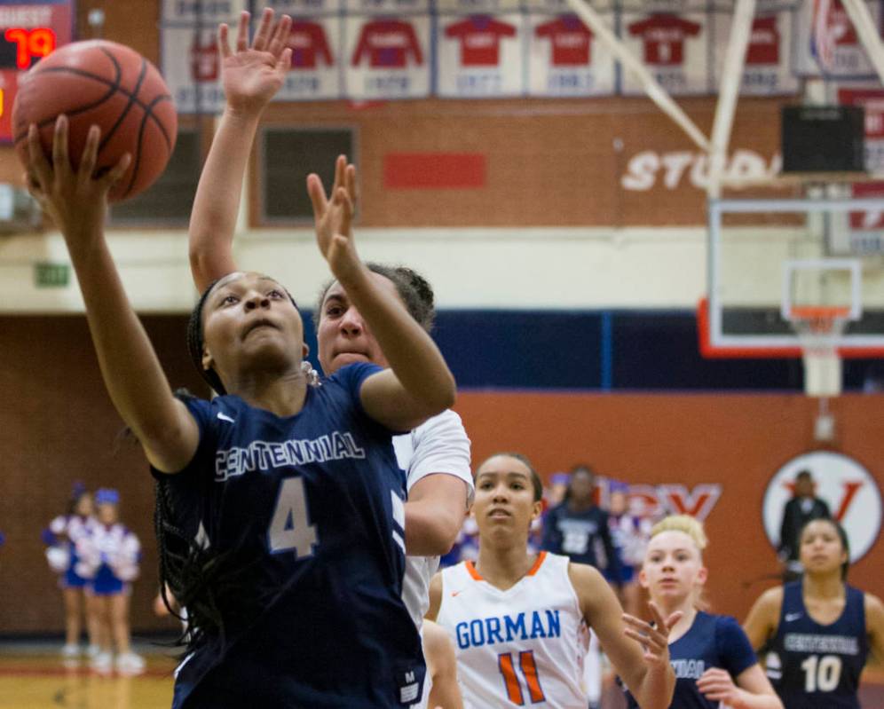 Centennial sophomore Taylor Bigby (4) drives past Bishop Gorman senior Olivia Smith (11) in ...