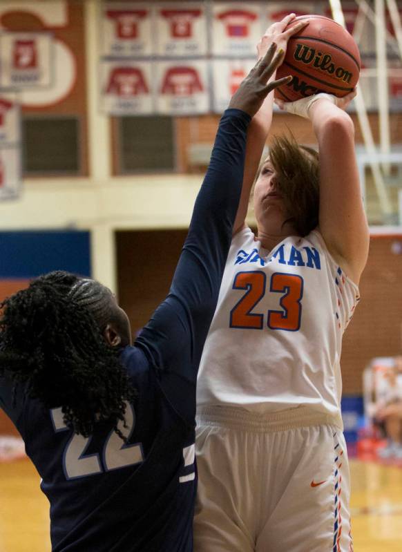 Bishop Gorman senior Tierney Holcombe (23) shoots over Centennial senior Eboni Walker (22) i ...