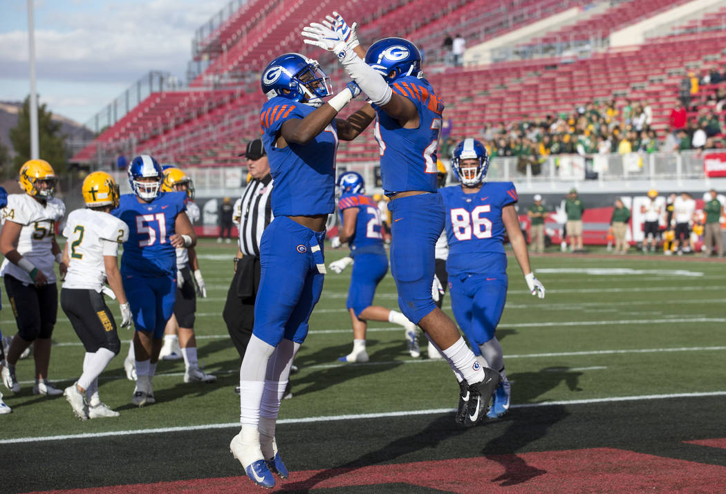 Bishop Gorman running back Amod Cianelli (23), right, celebrates his touchdown with Donovan ...