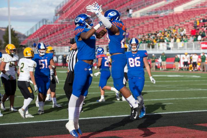 Bishop Gorman running back Amod Cianelli (23), right, celebrates his touchdown with Donovan ...