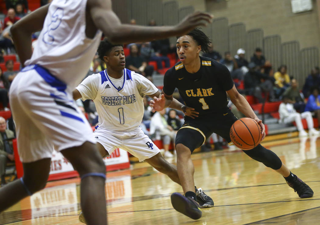 Clark’s Frankie Collins (1) drives against Desert Pines’ Semaj Threats (1) durin ...