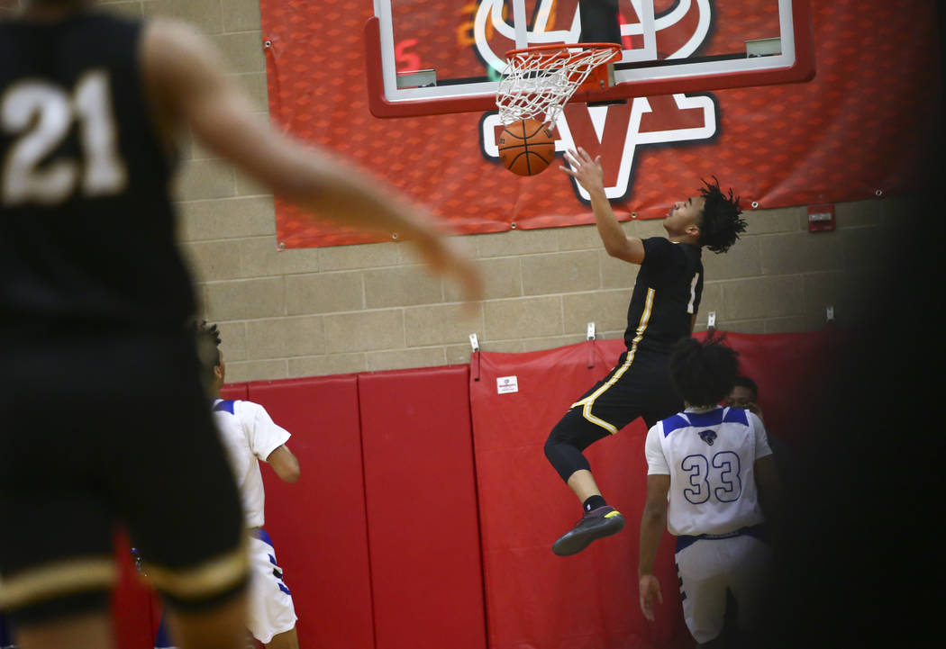 Clark’s Frankie Collins (1) dunks against Desert Pines during the first half of a Clas ...