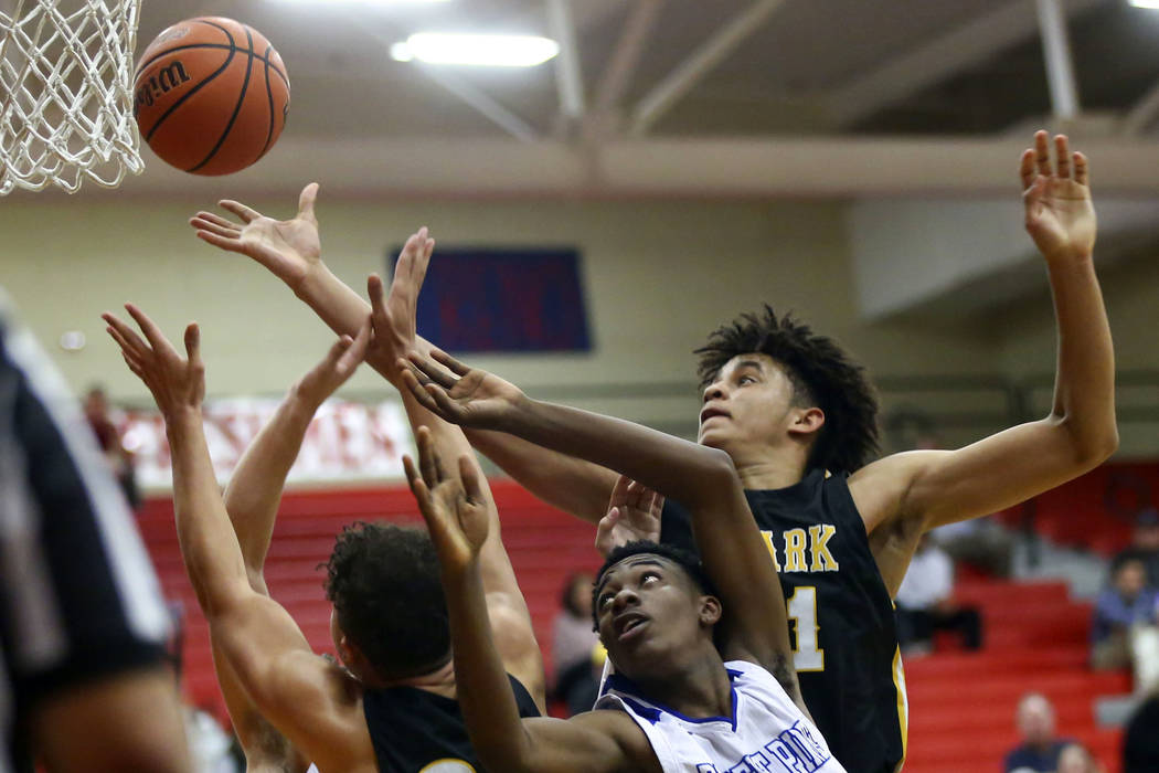 Clark’s Jalen Hill, right, battles for a rebound against Desert Pines’ Dayshawn ...