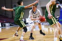 The Meadows guard Allen Fridman (24) moves the ball around Incline guard Johnny Redfern (11) ...