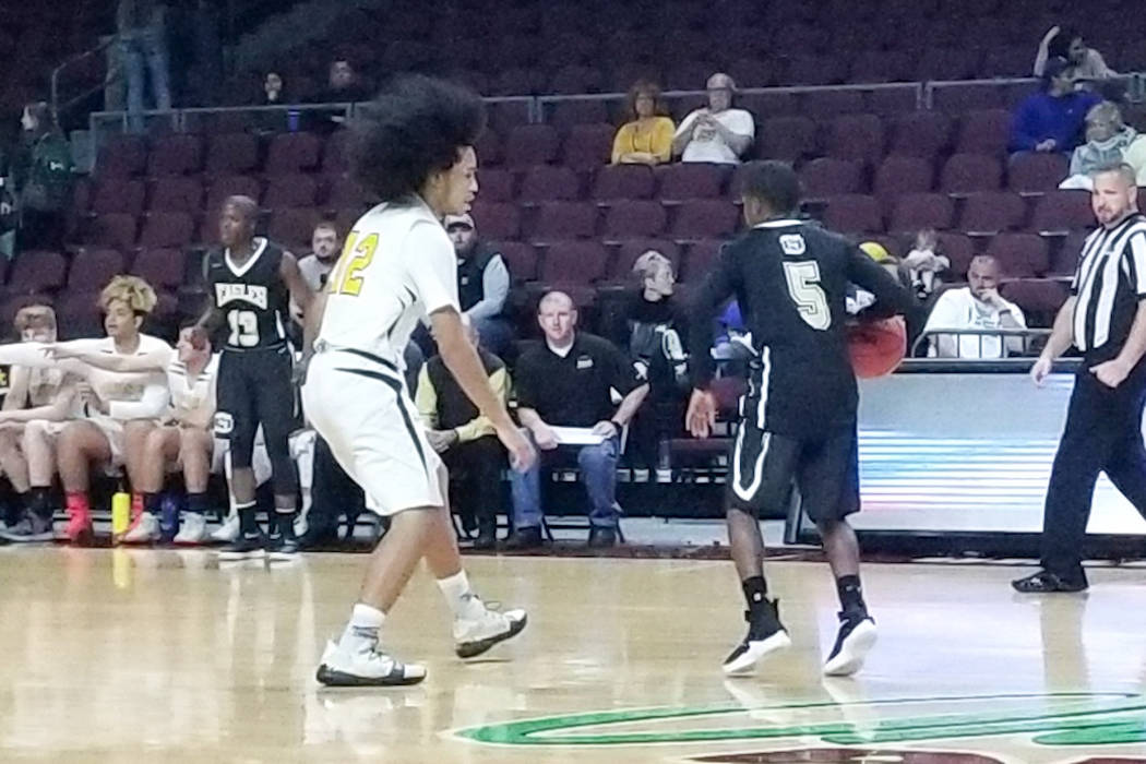 Spring Mountain’s Tony Branch, right, handles the ball as Mineral County’s Rober ...