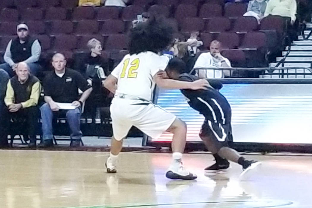 Spring Mountain’s Tony Branch, right, looks for a driving lane as Mineral County&#8217 ...