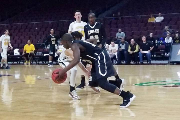 Spring Mountain’s Josiah Johnson drives past Mineral County’s Antonio Dominguez ...