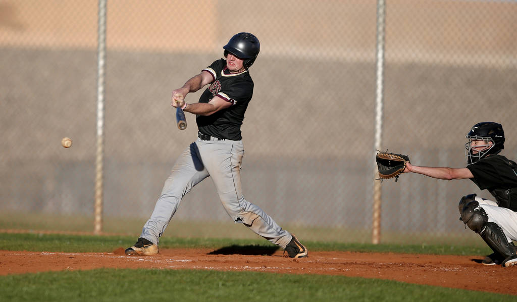 Faith Lutheran Jacob Ortega (8) gets a base hit against Silverado during a baseball game at ...