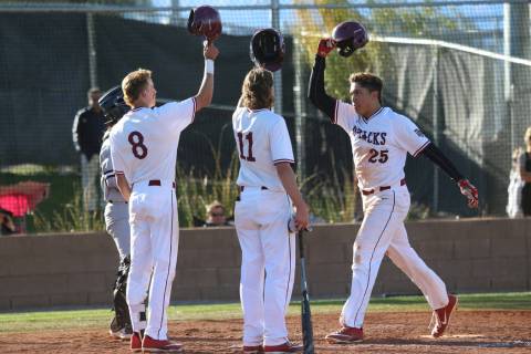 Desert Oasis’ Aaron Roberts (25) scores a run with a home run and celebrates with team ...