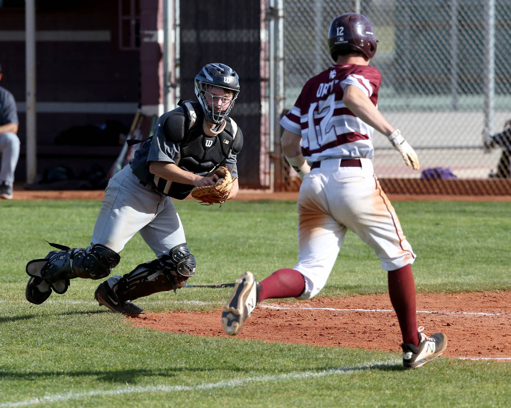 Silverado catcher Brant Hunt (18) looks to tag Cimarron-Memorial baserunner Anthony Ortiz (1 ...