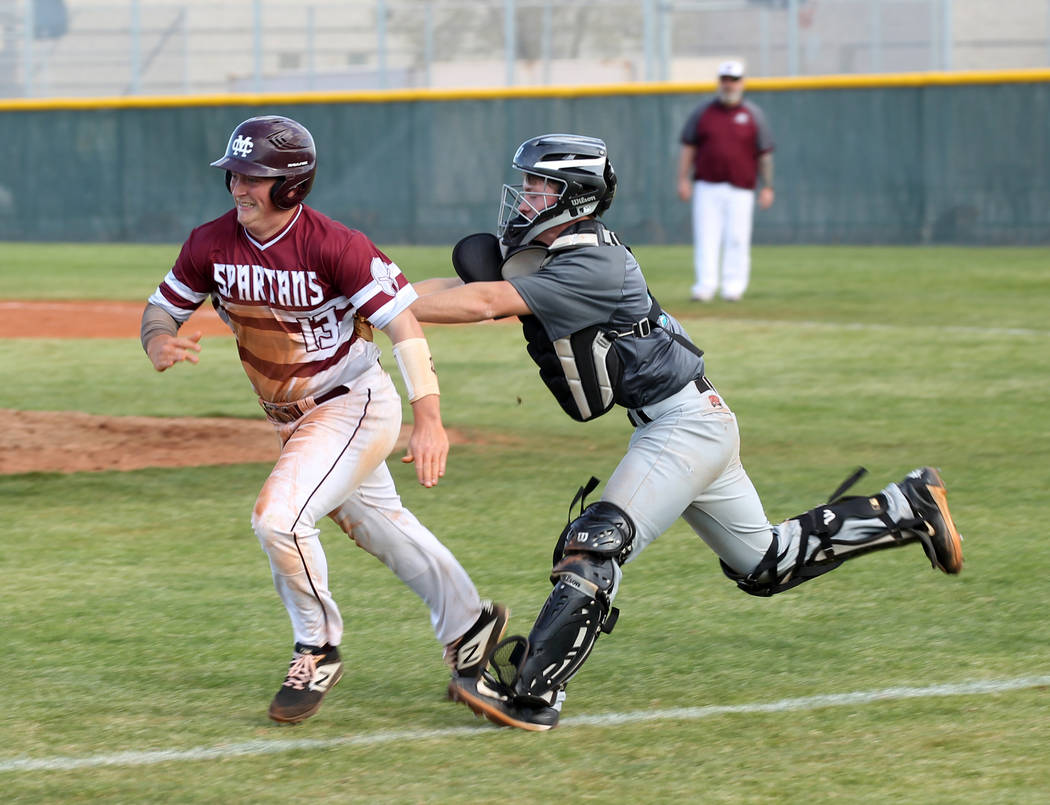 Silverado catcher Brant Hunt (18) tags out Cimarron-Memorial Lance Quaney (13) in a rundown ...