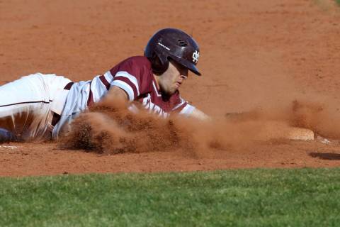 Cimarron-Memorial baserunner Lawrence Campa (15) slides safely into third base in the third ...