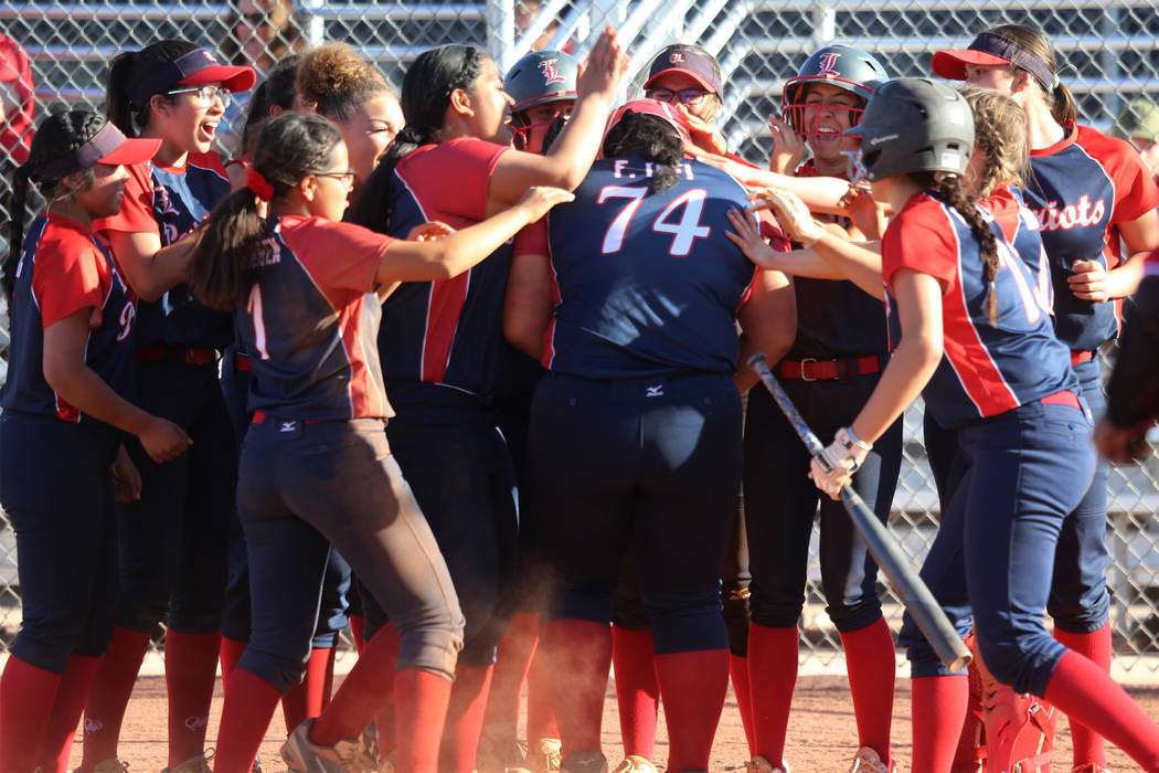 Liberty’s Fia Tofi (74) celebrates a two-run homer with her team in the softball game ...