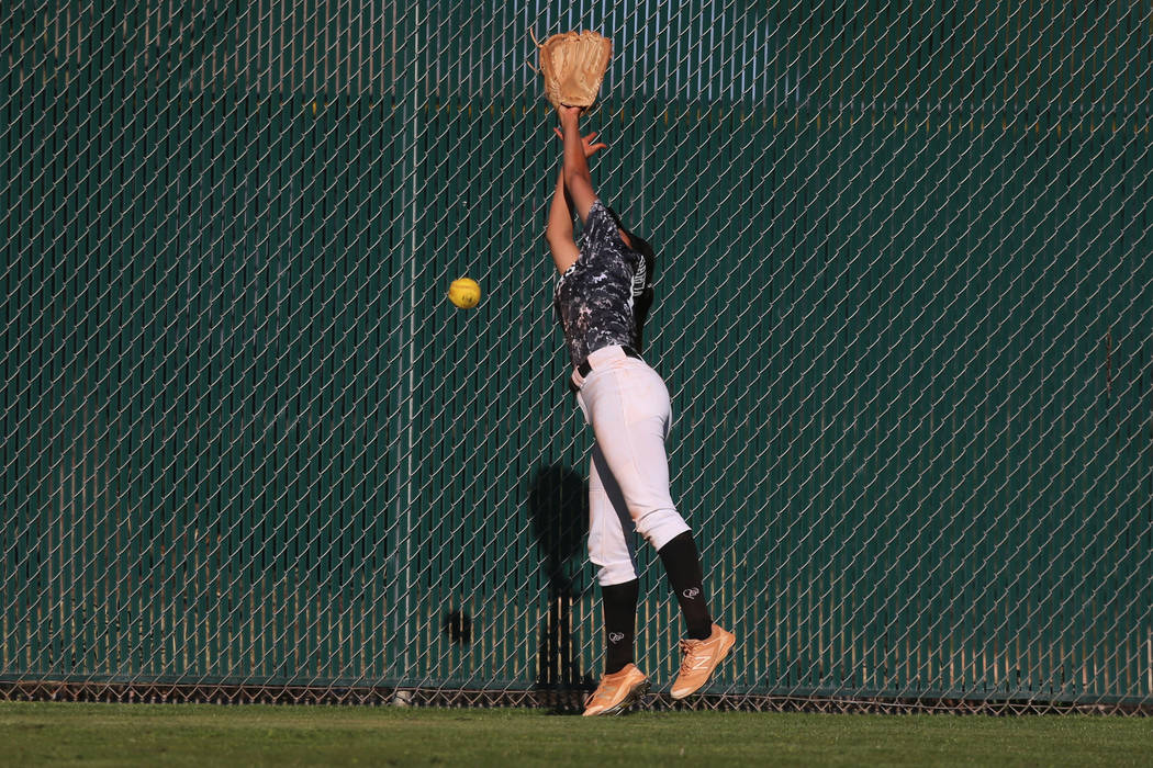 Desert Oasis Paisley Garcia (17) misses the ball to allow a hit by Liberty in the softball g ...