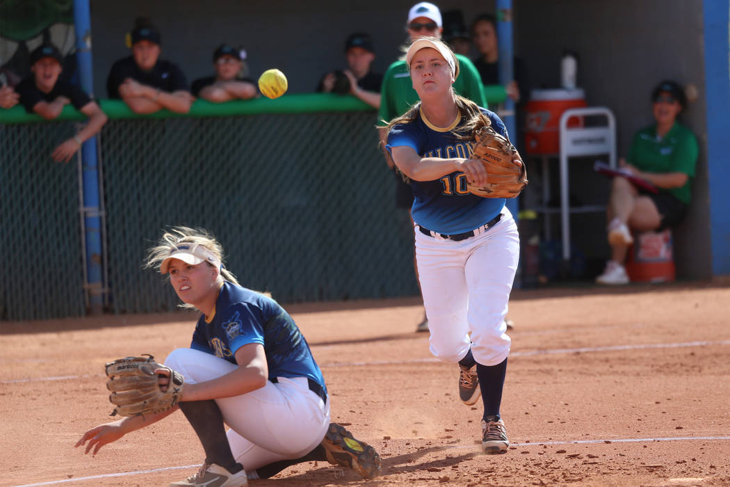 Foothill’s Makenzie Andrews (10) throws to first base for an out as Leah Becker (5) du ...
