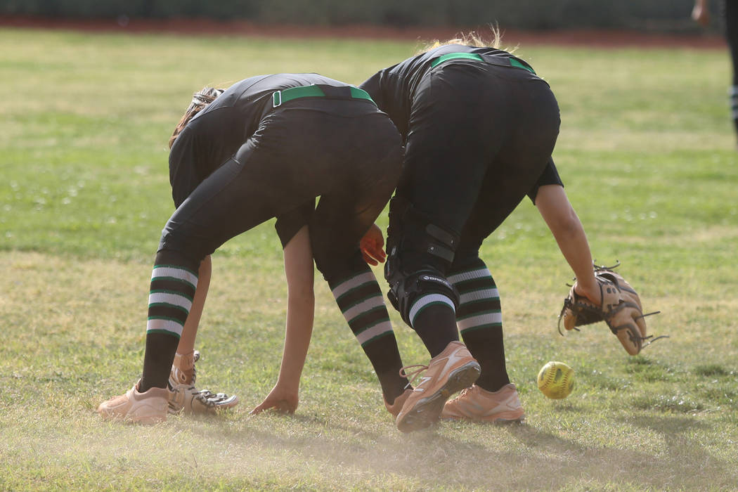 Green Valley’s Alyssa Vigil (8), left, and Cinthia Garcia (13), miss a fly ball in the ...