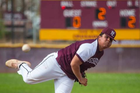 Faith Lutheran’s pitcher Christian Dijkman (21) sends another ball towards the plate v ...