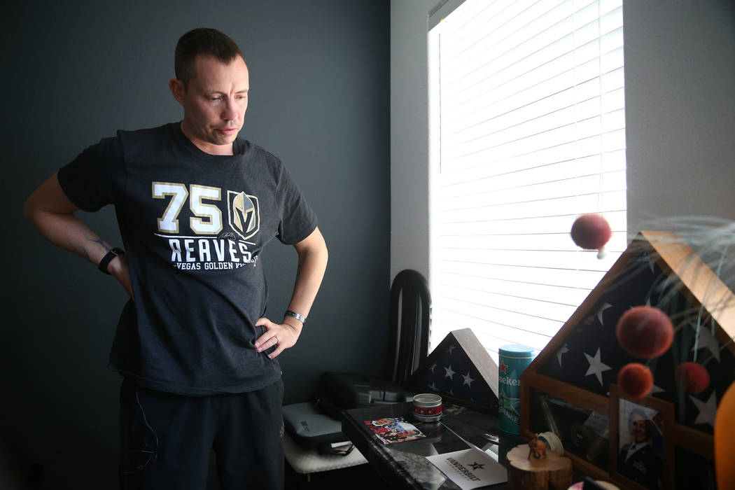 Chris Jachimiec looks at family photos at his home in Las Vegas, Friday, March 8, 2019. (Erik V ...
