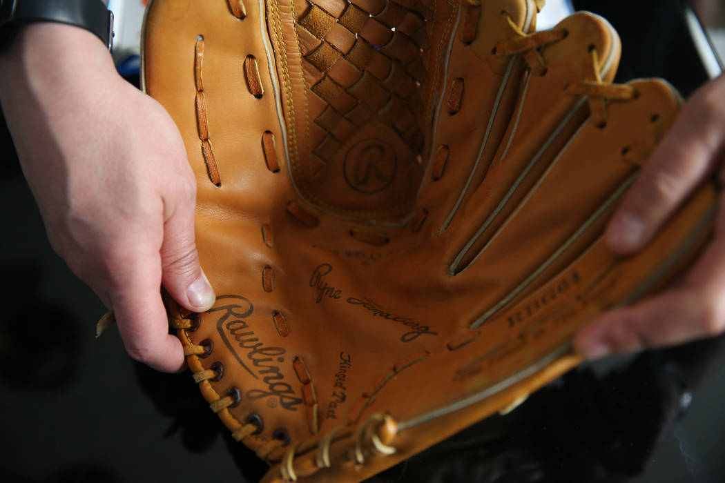 Chris Jachimiec shows a baseball glove that belonged to his brother Adam, Friday, March 8, 2019 ...