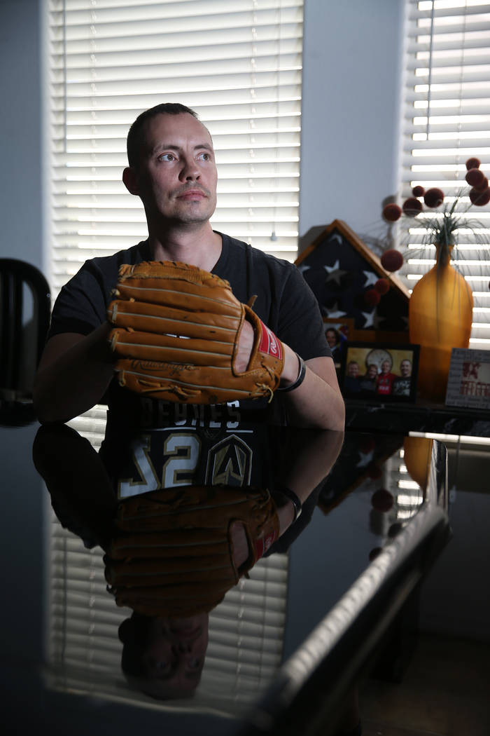 Chris Jachimiec at his home in Las Vegas, wears a baseball glove that belonged to his brother A ...