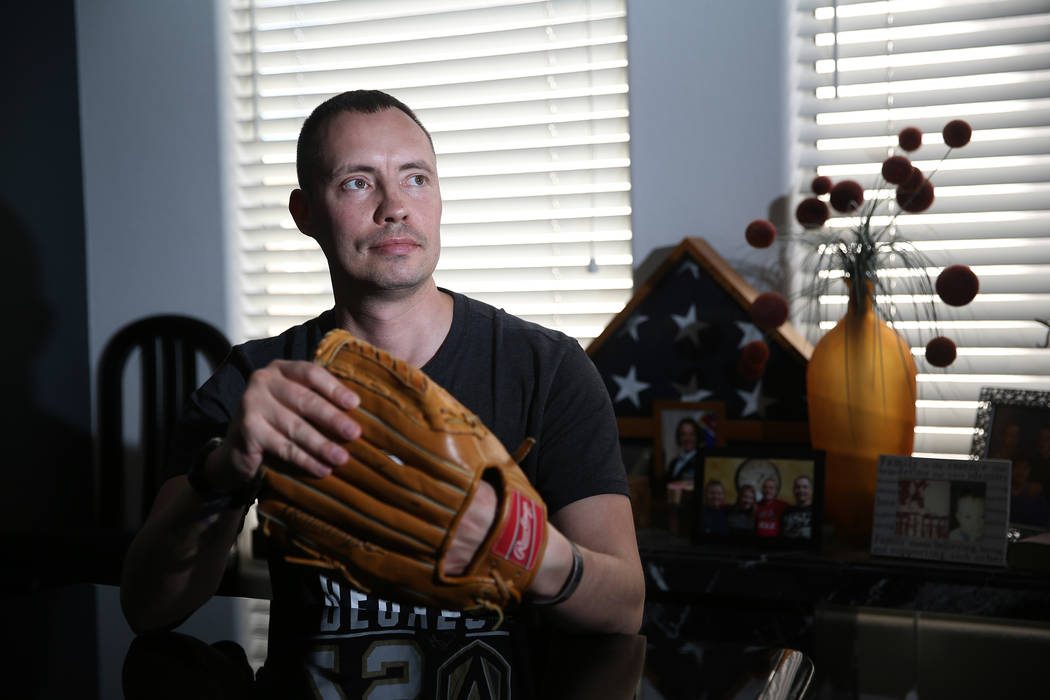 Chris Jachimiec at his home in Las Vegas, wears a baseball glove that belonged to his brother A ...