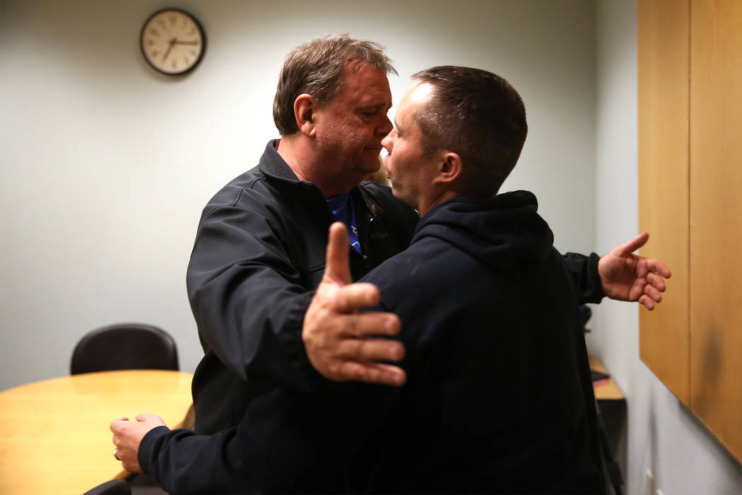 Chuck Reineck, left, hugs Chris Jachimiec after their support group meeting at the Rainbow Libr ...