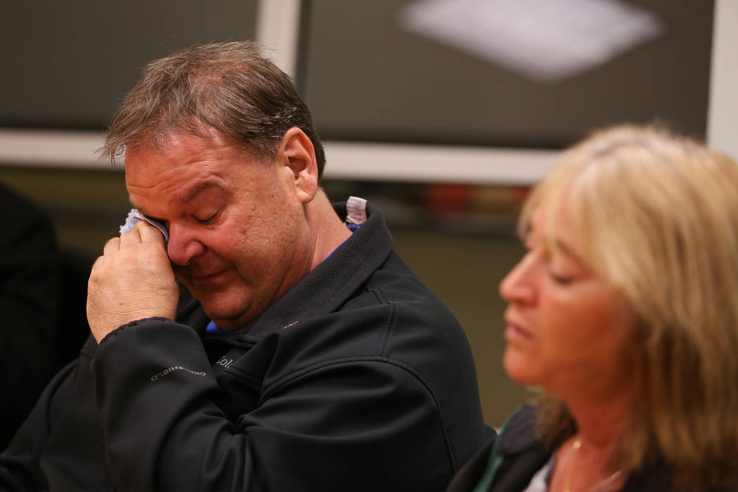 Chuck Reineck, left, wipes tears while speaking about the loss of his son during a support grou ...