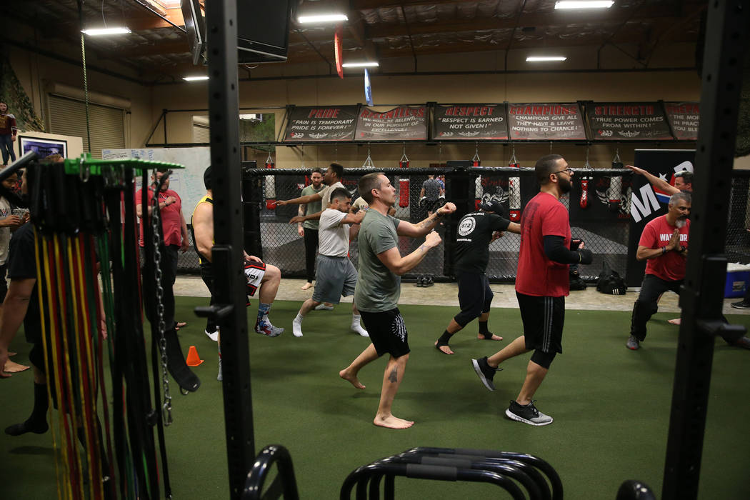 Military veteran Chris Jachimiec works out during a Merging Vets And Players class at Xtreme Co ...