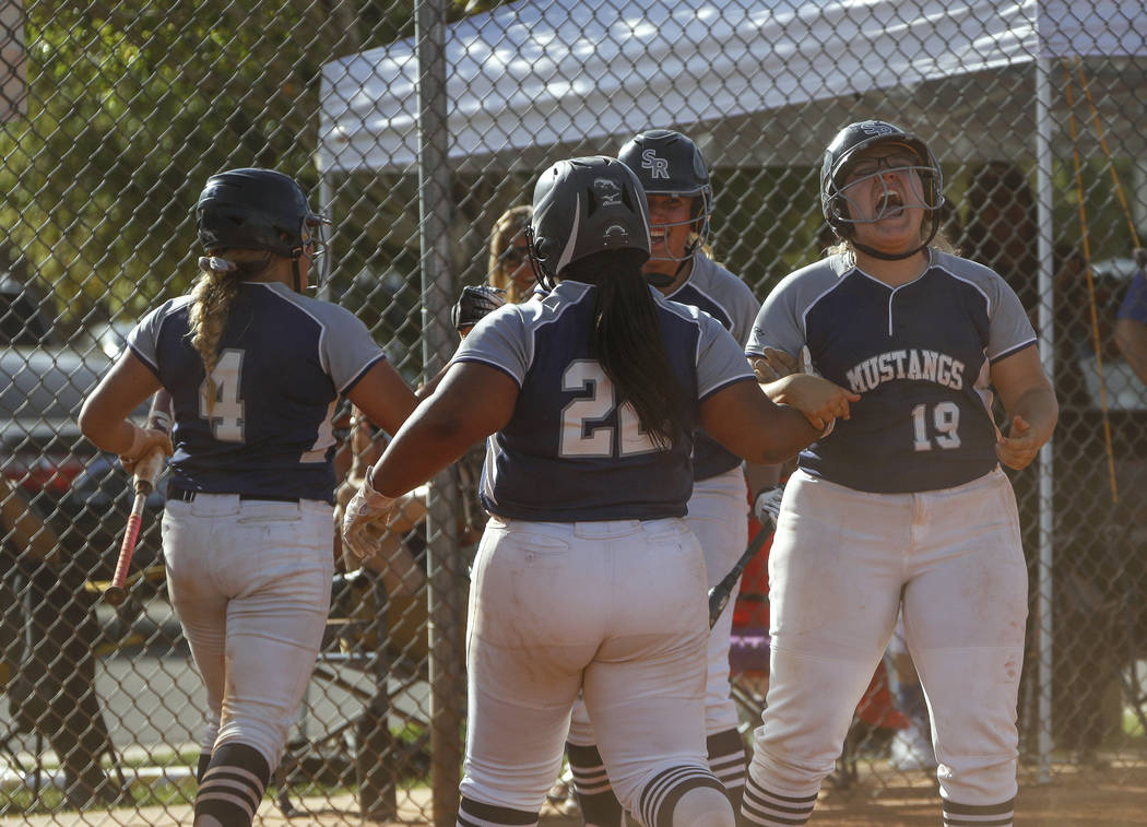 Shadow Ridge players cheers after catcher Shea Clements (4) scores the first run of the game ...