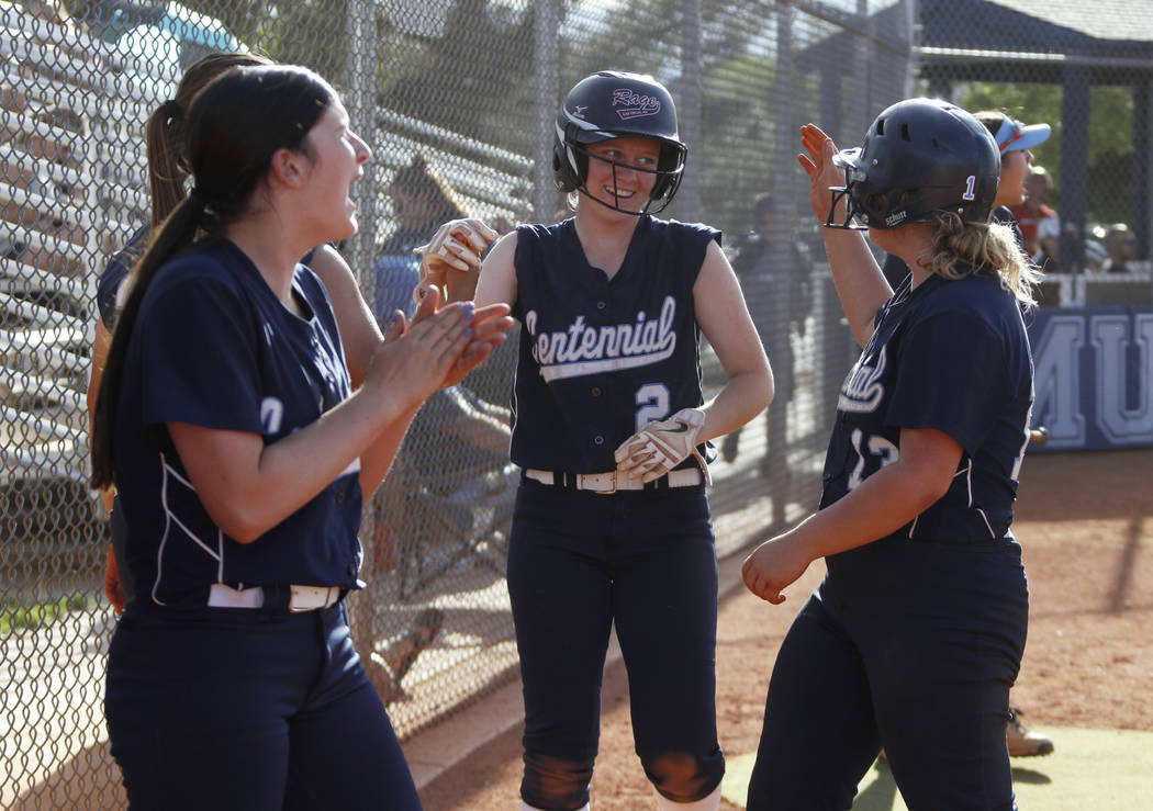Centennial infielder Ryan Rogers (2) is cheered on by her teammates after scoring a run in t ...