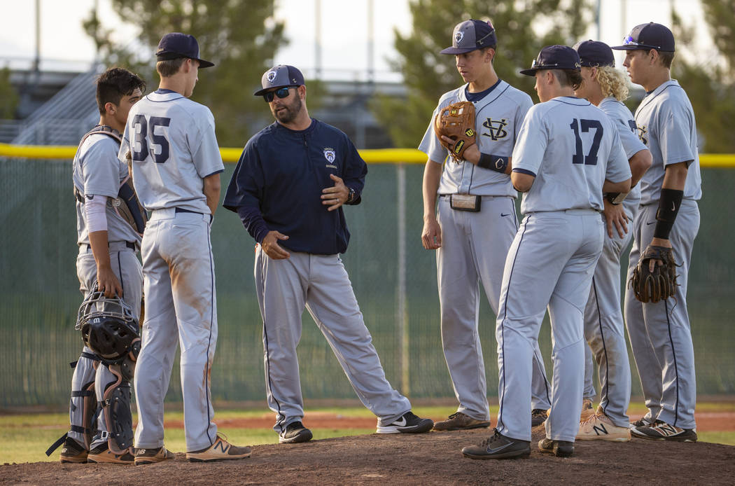 Spring Valley head coach Paul Bassett meets with his players during a time out versus Libert ...